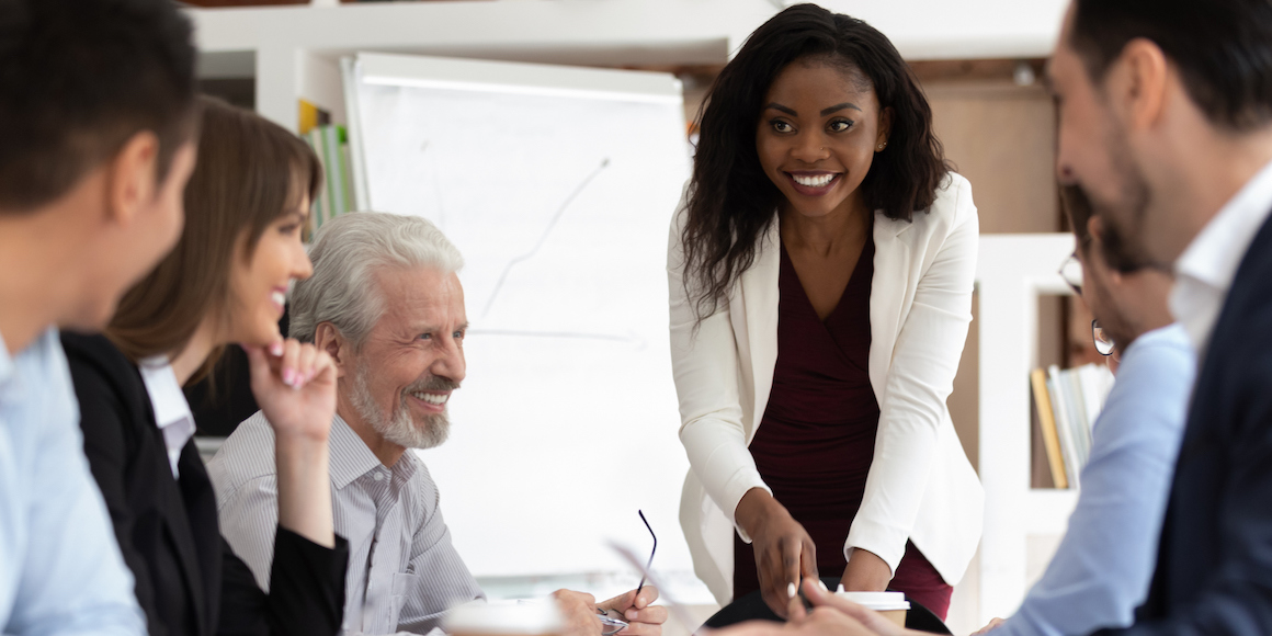 Smiling employees at business meeting