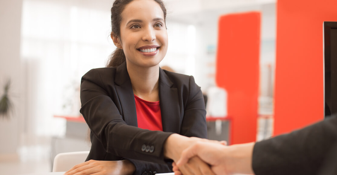 Businesswoman shaking hands with someone.